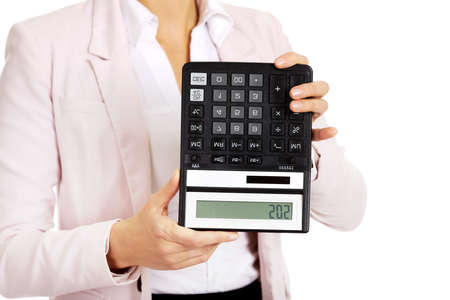 Worried business woman shows sos on calculator.の写真素材