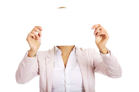 Business woman covering face with blank paper sheet.の写真素材