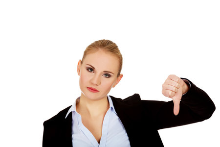 Unhappy businesswoman with thumbs down gesture.