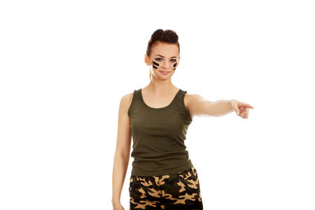 Young soldier woman pointing for something.の写真素材