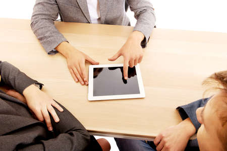 Business meeting-man showing something on tablet.の写真素材