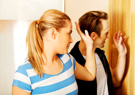 Happy couple going out and waving to friends.の写真素材