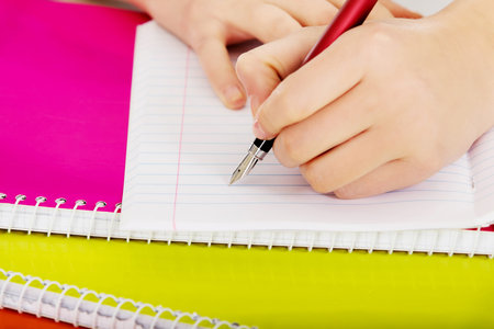 Teenage woman hand doing a homework.