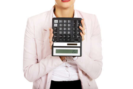 Worried business woman shows sos on calculator.の写真素材