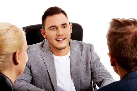 Business meeting - three people sitting and talking.の写真素材