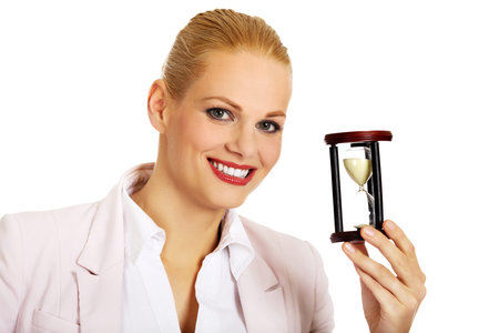 Young business woman holding hourglass.Time concept.