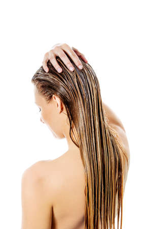 Photo of woman applying hair egg conditionerの写真素材