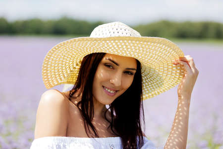 Happy woman in summer field. Young girl relax outdoors. Freedom conceptの写真素材