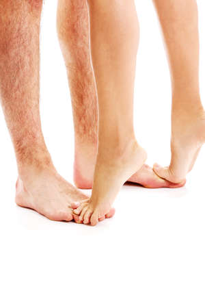 woman and man legs with foot isolated on white.の写真素材