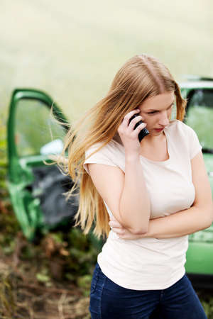 Female driver making phone calls after car accidentの写真素材