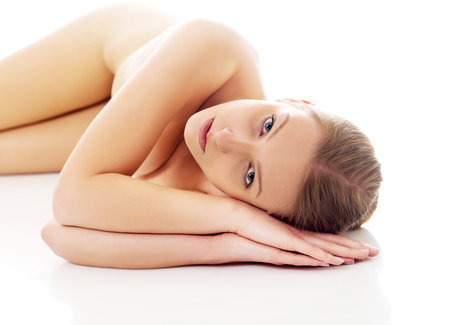 Nude woman lying on the floorの写真素材