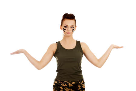 Young soldier woman presenting something on open palmの写真素材