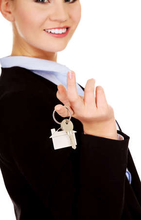 Business woman real estate agent holding keysの写真素材