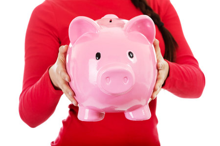 Young casual woman holding a piggybankの写真素材