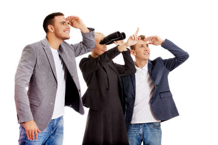 Business team looking into one direction-woman using binocularsの写真素材