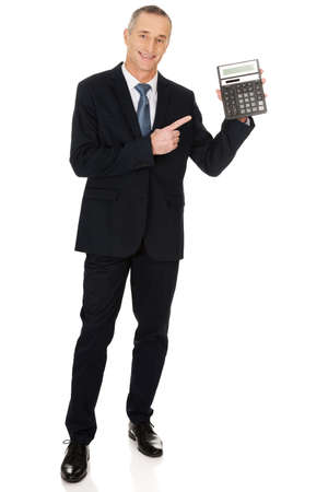 Happy businessman pointing on calculatorの写真素材