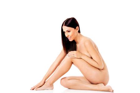 Young nude woman sitting on the floorの写真素材