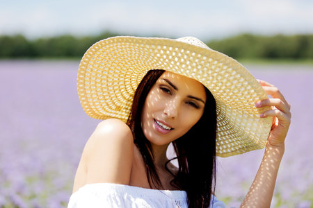 Happy woman in summer field. Young girl relax outdoors. Freedom concept.の写真素材