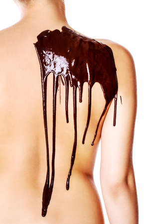 young girl in the spa salon, chocolate body wrap treatment, skin rejuvenation. Beauty treatment conceptの写真素材