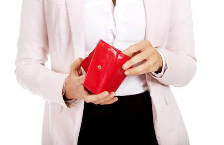 Worried business woman looking into her empty walletの写真素材