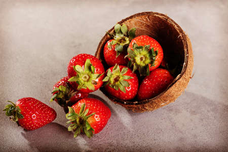 Juicy strawberry in coconut shell.の写真素材