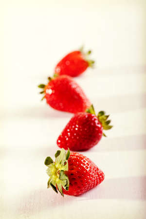 Four juicy strawberry on the table.の写真素材