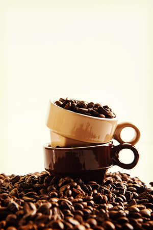 Two cups with coffee seeds.の写真素材