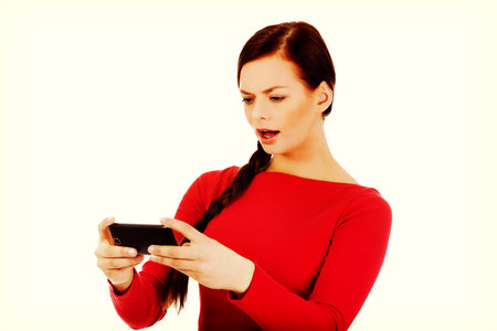 Young student woman yelling to the mobile phone.