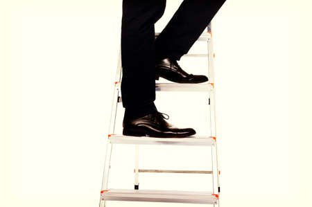 Male legs climbing a ladderの写真素材