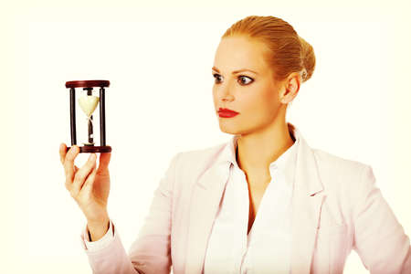 Young business woman holding hourglass.Time concept.の写真素材