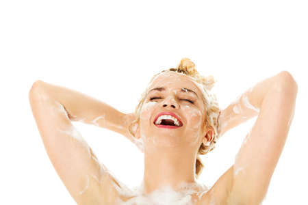 Woman washing her blond hairの写真素材