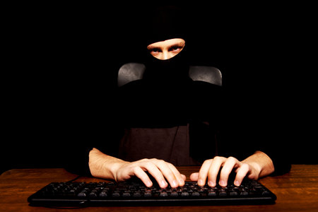 Dangerous hacker in black balaclava