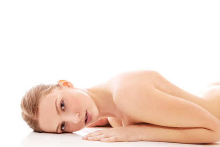 Nude woman lying on the floorの写真素材