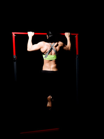 Bodybuilder women excercising on rod