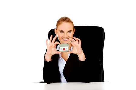 Young business woman presenting a house modelの写真素材