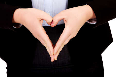 Business woman making a heart shape with her handsの写真素材
