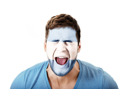 Screaming man with Argentina flag on face.の写真素材