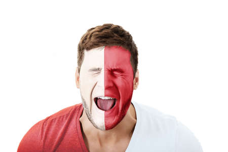 Screaming man with Malta flag painted on face.の写真素材