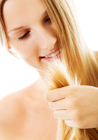 Beautiful woman holding her healthy hair, isolated on white.の写真素材