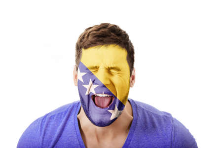 Man with Bosnia and Herzegovina flag on face.の写真素材