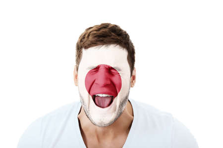 Screaming man with Japan flag on face.の写真素材