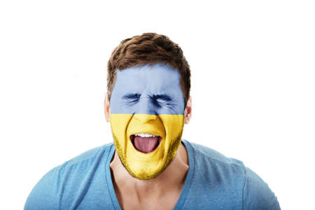 Screaming man with Ukraine flag on face.の写真素材