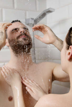 Young couple taking shower.の写真素材