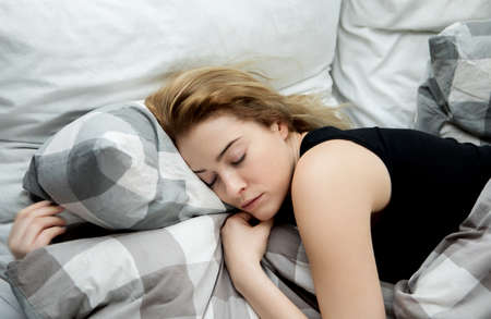 Young woman sleeping in her bed.の写真素材