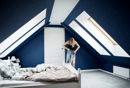 Woman pulling on tight jeansの写真素材