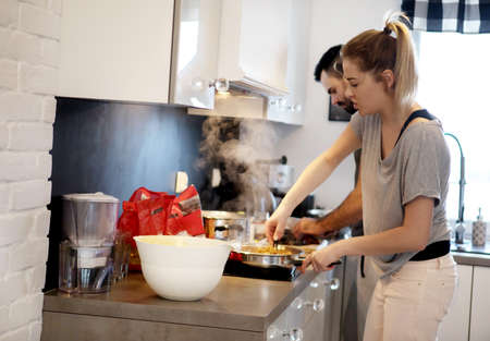 Family of two preparing delicious pasta.の写真素材