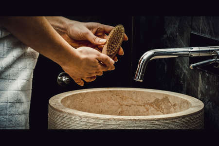 Woman cleaning her nails.の写真素材