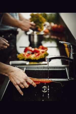 Brother and sisters cooking meal together.の写真素材