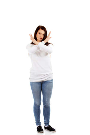 Young angry screaming woman gesturing stop signの写真素材