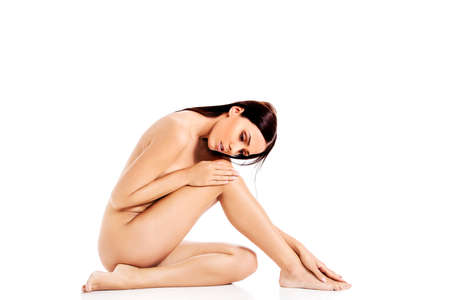 Young nude woman sitting on the floorの写真素材